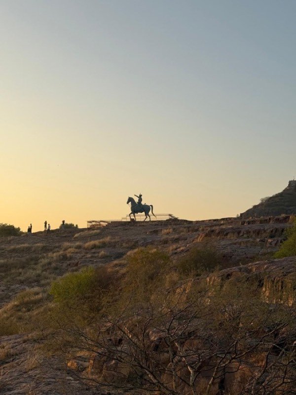 The horseman silhouette on the ridge at sunset