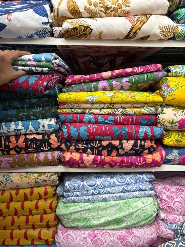 Stacks of block-printed cloth on a shop's shelves
